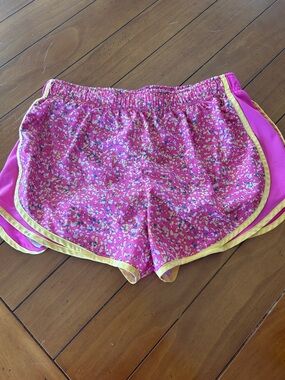 Nike Women’s Pink Floral Athletic Shorts with Yellow Trim